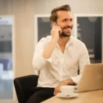 AI customer service representative assisting small business owner with phone call in bright, professional environment