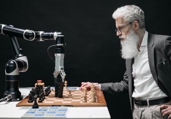 Elderly man playing chess against a robotic arm, illustrating the debate of robots vs humans in intelligence and decision-making