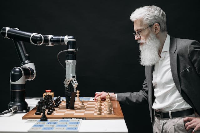 Elderly man playing chess against a robotic arm, illustrating the debate of robots vs humans in intelligence and decision-making